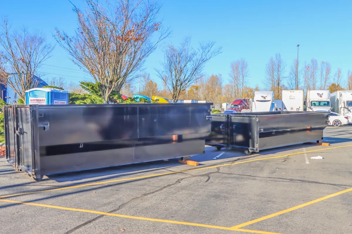 Professional dumpster rental service with roll-off container on residential driveway in Tipp City